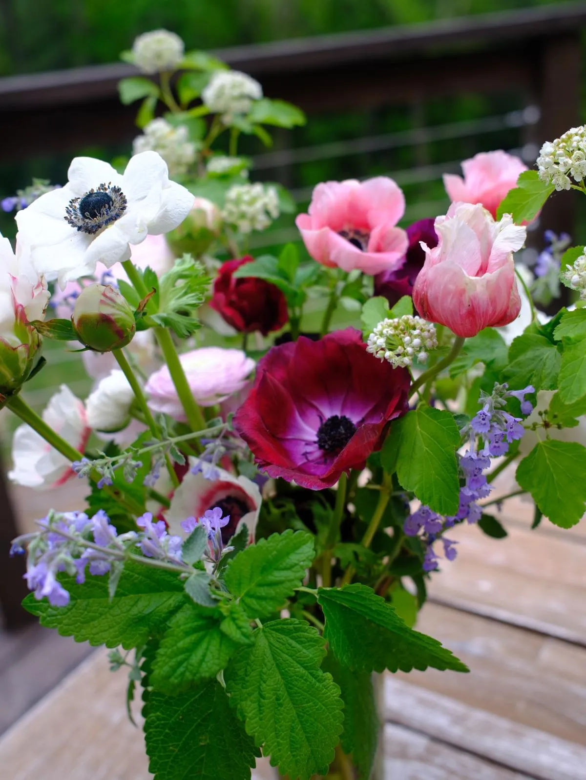 lush deep red and pale purple, pinks, whites and green floral arrangement